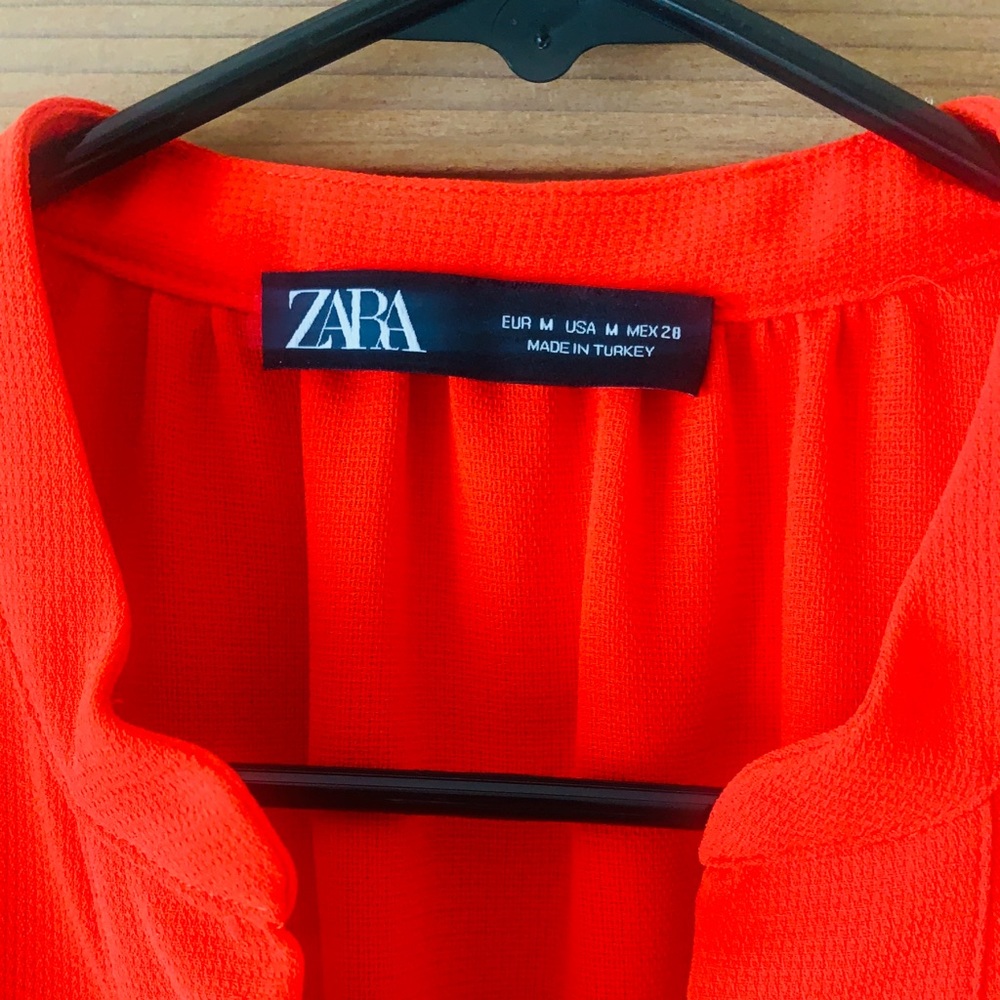 Bright red Zara dress, lightweight, deep V with ornamentation.